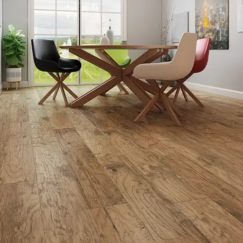 Laminate flooring close up with stylish wooden table and chairs